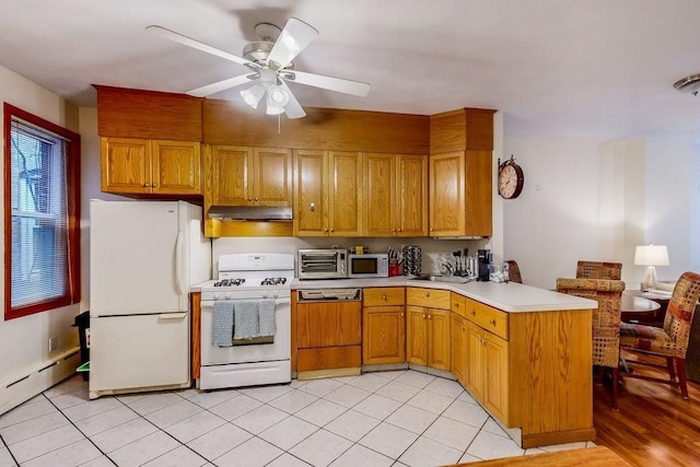 kitchen featuring white appliances, under cabinet range hood, a peninsula, light countertops, and a baseboard heating unit