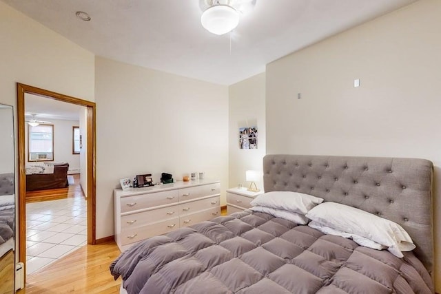 bedroom with light wood finished floors and baseboards