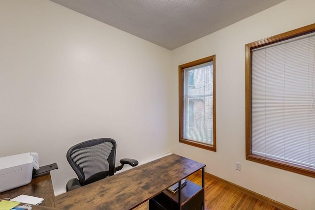 office space featuring wood finished floors and baseboards