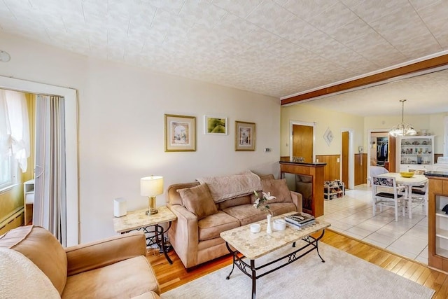living room featuring light wood finished floors and a chandelier