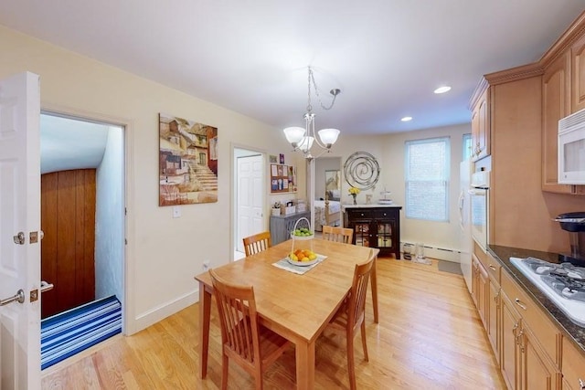 dining space featuring a chandelier, light wood finished floors, recessed lighting, and a baseboard radiator