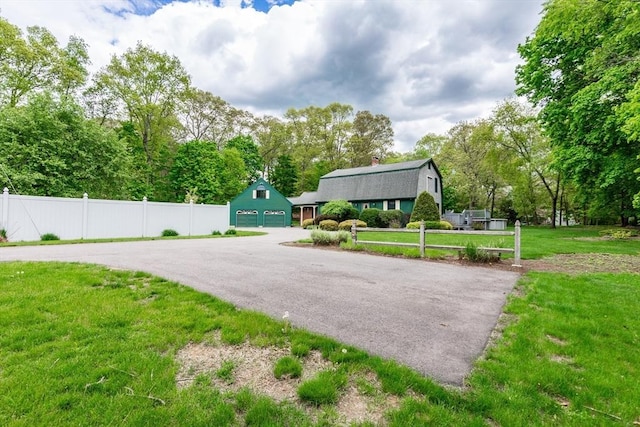 view of property's community featuring a garage and driveway