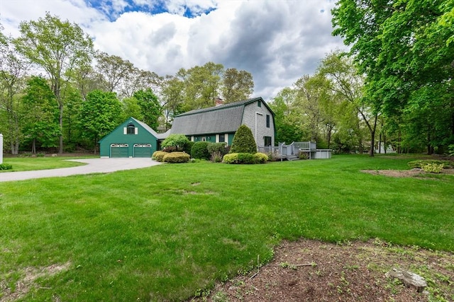 view of front of property with a gambrel roof, a garage, a front lawn, and driveway
