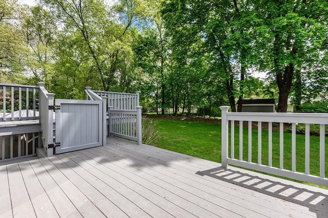 deck featuring a yard and view of scattered trees