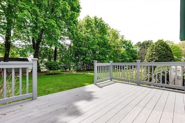 wooden deck with a yard and view of scattered trees
