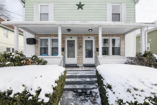 view of snow covered property entrance