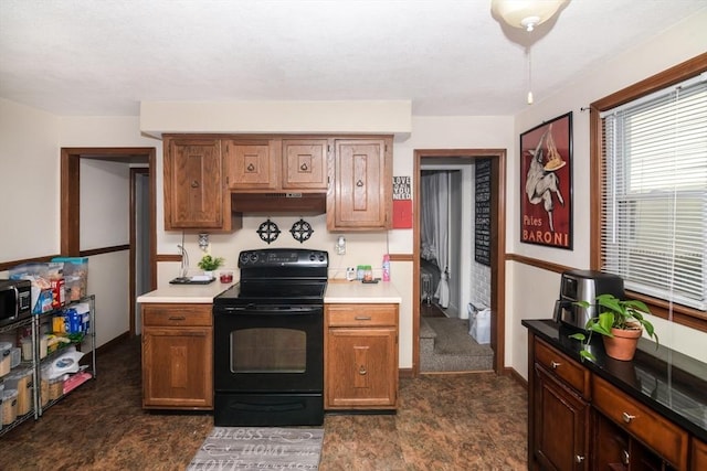 kitchen featuring black / electric stove and dark carpet