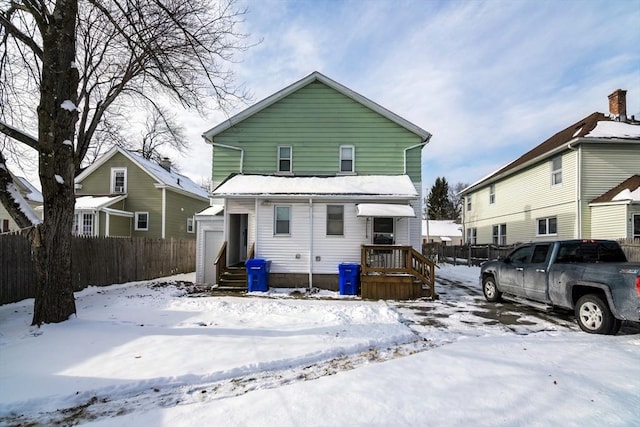 view of snow covered rear of property