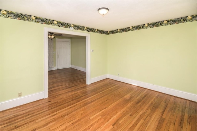 unfurnished room with hardwood / wood-style floors