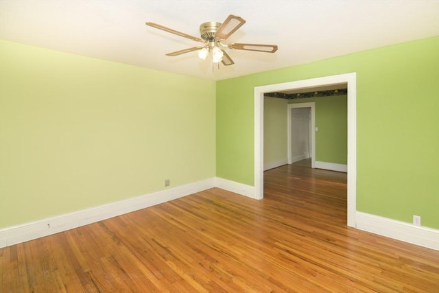 spare room with hardwood / wood-style flooring and ceiling fan