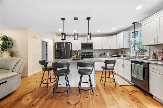 1085 Southbridge Rd, Warren, MA 01585 - kitchen with appliances with stainless steel finishes, white cabinets, a kitchen breakfast bar, light stone counters, and recessed lighting