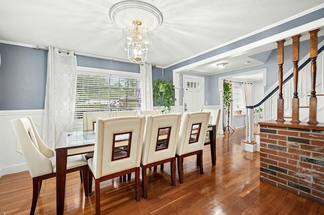 50 Depot St, Milford, MA 01757 - dining room with wood finished floors, a decorative wall, crown molding, a wainscoted wall, and a chandelier