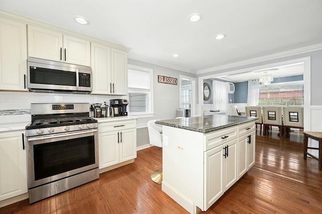 50 Depot St, Milford, MA 01757 - kitchen featuring stainless steel appliances, crown molding, wood-type flooring, a chandelier, and a center island