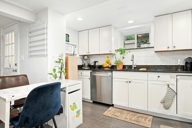 50 Depot St, Milford, MA 01757 - kitchen with stainless steel dishwasher, a sink, white microwave, tasteful backsplash, and white cabinetry