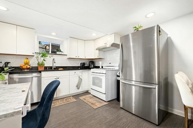 50 Depot St, Milford, MA 01757 - kitchen with stainless steel appliances, a sink, under cabinet range hood, backsplash, and dark wood-type flooring