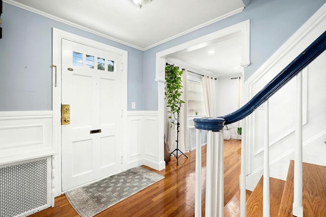 50 Depot St, Milford, MA 01757 - foyer entrance featuring wood finished floors, stairs, a wainscoted wall, ornamental molding, and a decorative wall