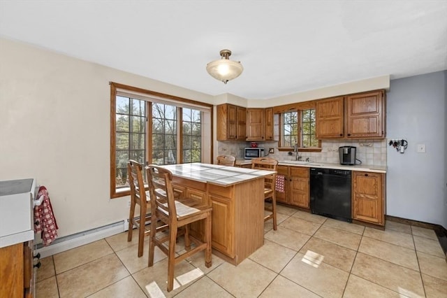 kitchen with dishwasher, a breakfast bar, backsplash, sink, and light tile patterned floors