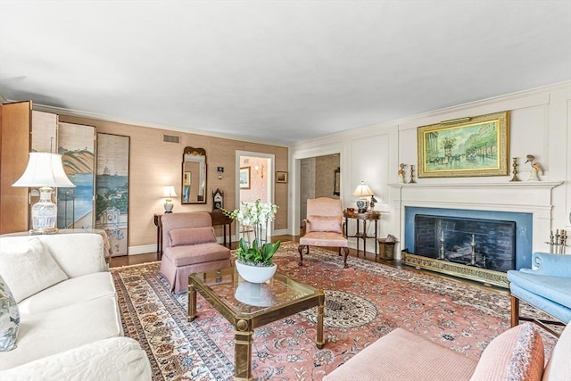 living room featuring a fireplace and crown molding