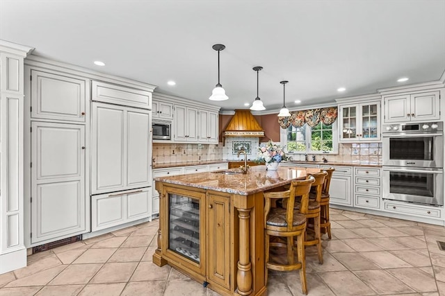 kitchen with built in appliances, recessed lighting, decorative backsplash, light stone countertops, and glass insert cabinets