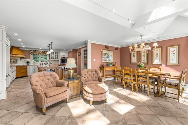 living room featuring track lighting, recessed lighting, a chandelier, and ornamental molding