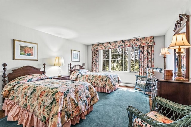 bedroom with a baseboard heating unit and carpet flooring