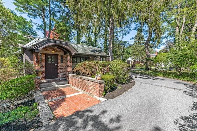 view of exterior entry featuring brick siding