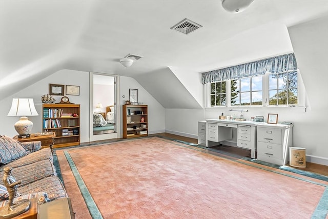 unfurnished office featuring vaulted ceiling and baseboards