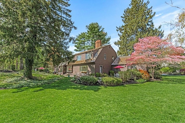 view of property exterior with a yard and a chimney