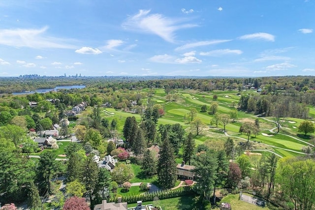 aerial overview of property's location with a local golf course, a tree filled landscape, and a nearby body of water