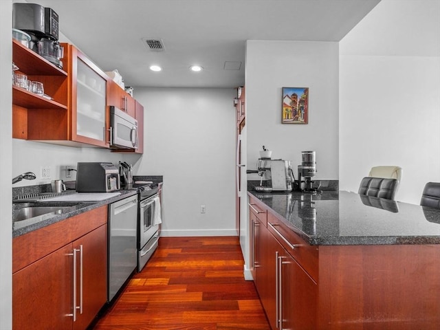 150 Cambridge St Unit 403, Cambridge, MA 02141 - kitchen with appliances with stainless steel finishes, dark wood-style flooring, baseboards, recessed lighting, and glass insert cabinets
