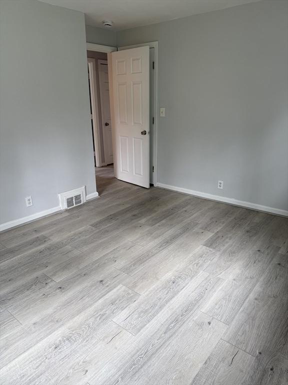 796 Charlton St, Southbridge, MA 01550 - unfurnished room with wood finished floors, baseboards, and a smoke detector