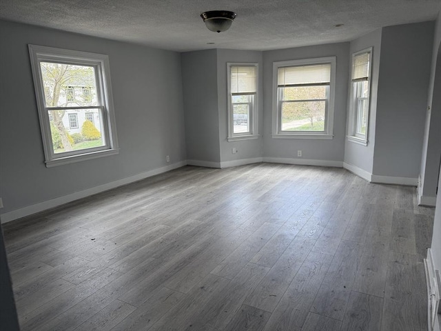 796 Charlton St, Southbridge, MA 01550 - unfurnished room with a textured ceiling, plenty of natural light, hardwood / wood-style flooring, and baseboards