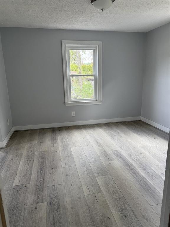 796 Charlton St, Southbridge, MA 01550 - unfurnished room featuring wood finished floors, a textured ceiling, and baseboards