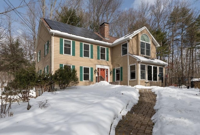 colonial house featuring solar panels