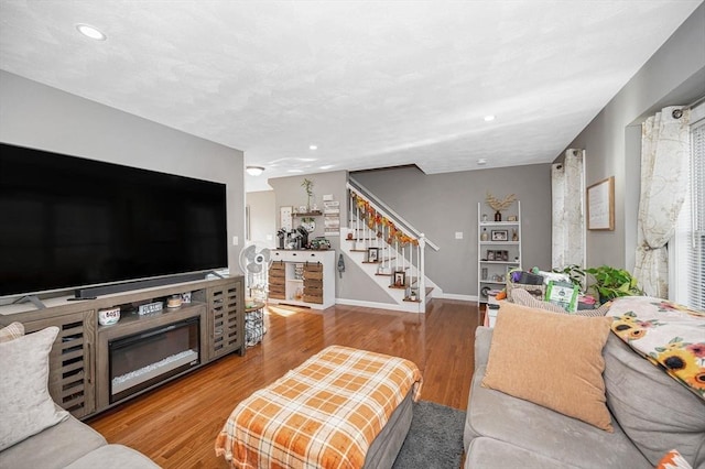 15 Alton St Unit 16, Lowell, MA 01852 - living room with stairway, baseboards, wood finished floors, recessed lighting, and a fireplace