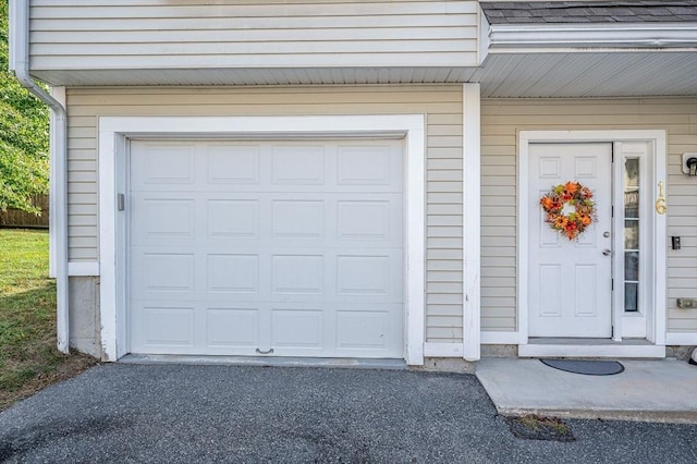 15 Alton St Unit 16, Lowell, MA 01852 - property entrance featuring a garage and asphalt driveway