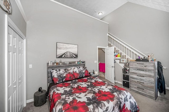 15 Alton St Unit 16, Lowell, MA 01852 - bedroom with carpet flooring, a closet, baseboards, and high vaulted ceiling