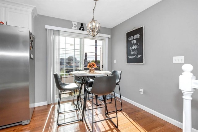 15 Alton St Unit 16, Lowell, MA 01852 - dining room featuring wood finished floors, baseboards, and a chandelier