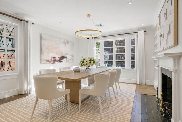 dining room featuring hardwood / wood-style flooring and ornamental molding