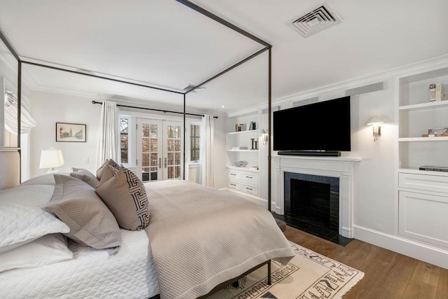 bedroom featuring dark wood-type flooring and french doors