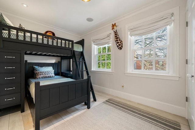 bedroom featuring light hardwood / wood-style flooring and ornamental molding