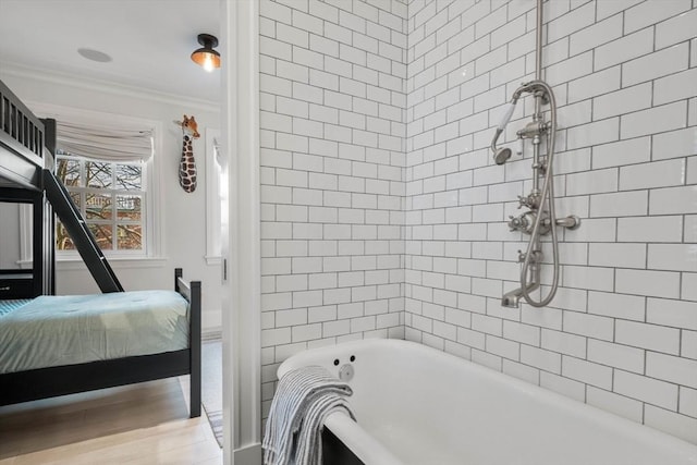 bathroom featuring ornamental molding and plus walk in shower