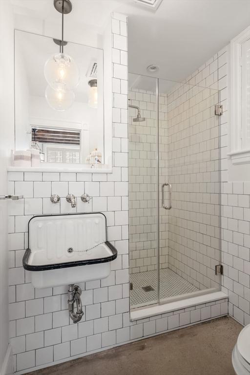 bathroom with toilet and walk in shower