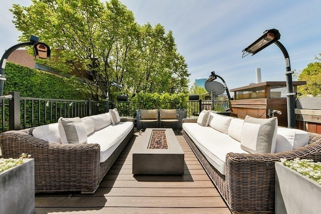 deck with an outdoor living space with a fire pit