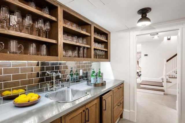 bar with tasteful backsplash and sink