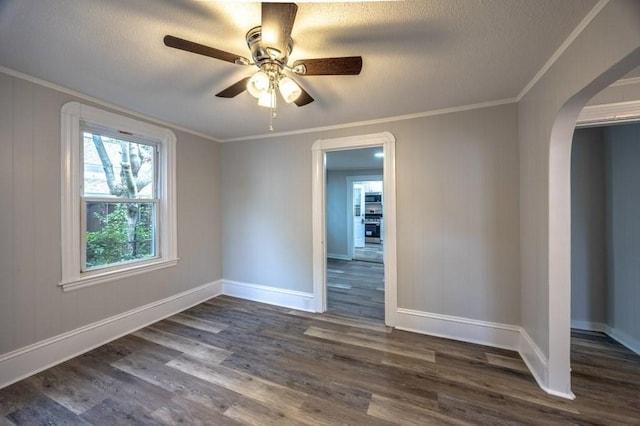 338-340 Main St, Fairhaven, MA 02719 - unfurnished room with dark wood finished floors, a textured ceiling, arched walkways, ceiling fan, and ornamental molding