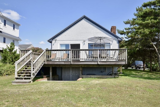 rear view of house with a chimney, stairway, a lawn, and a wooden deck