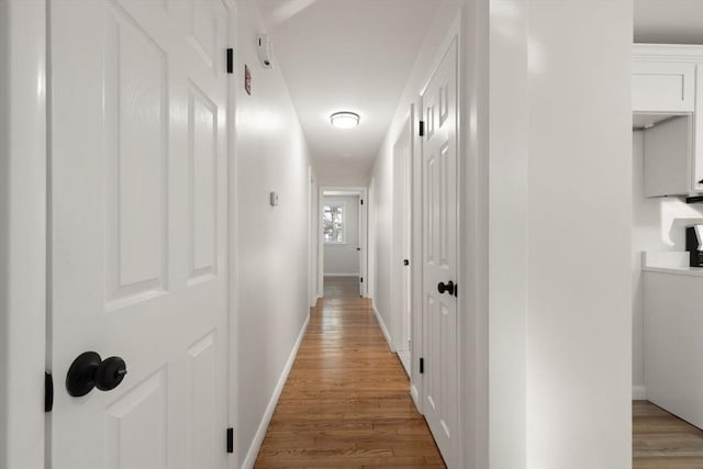 hallway with light hardwood / wood-style flooring