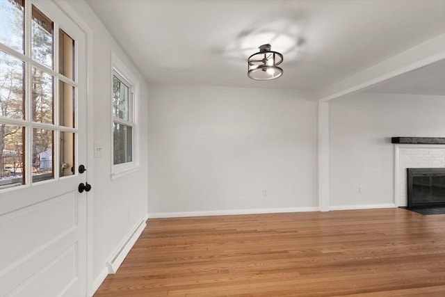 interior space with a fireplace and light wood-type flooring