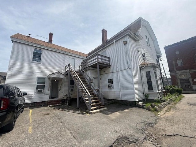 91 Summer St Unit 3, Lawrence, MA 01840 - back of house with a balcony, stairway, and uncovered parking